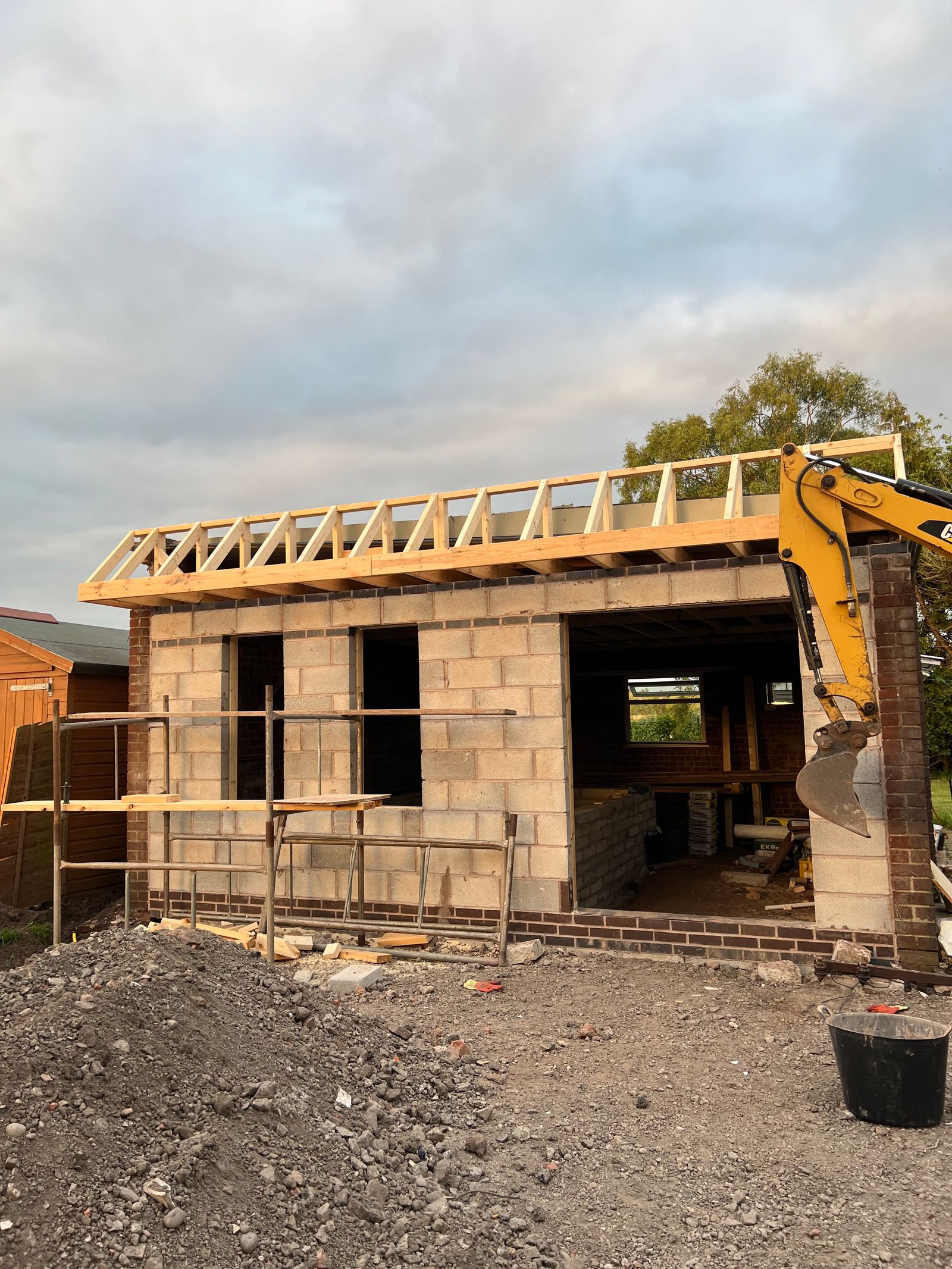 Construction of a wall and roof over a dog hydrotherapy building.